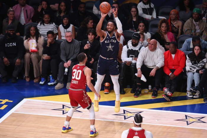 Feb 18, 2024; Indianapolis, Indiana, USA; Eastern Conference guard Donovan Mitchell (45) of the Cleveland Cavaliers attempts a three-point basket against Western Conference guard Stephen Curry (30) of the Golden State Warriors during the fourth quarter in the 73rd NBA All-Star Game at Gainbridge Fieldhouse.